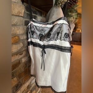 White Ann Taylor satin tank style blouse with black trim details.